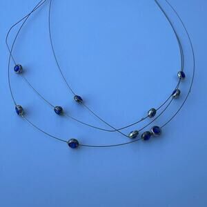 Icing women's choker necklace multiple strands with attached blue beads.